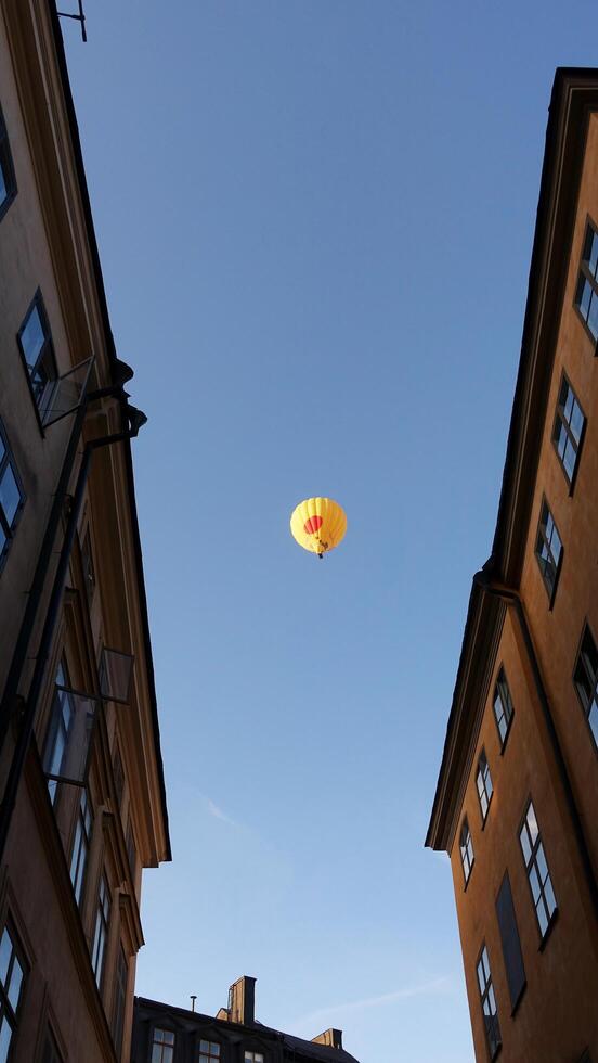 walking in the historic center of Stockholm. You can see the construction site cranes and a hot air balloon. photo