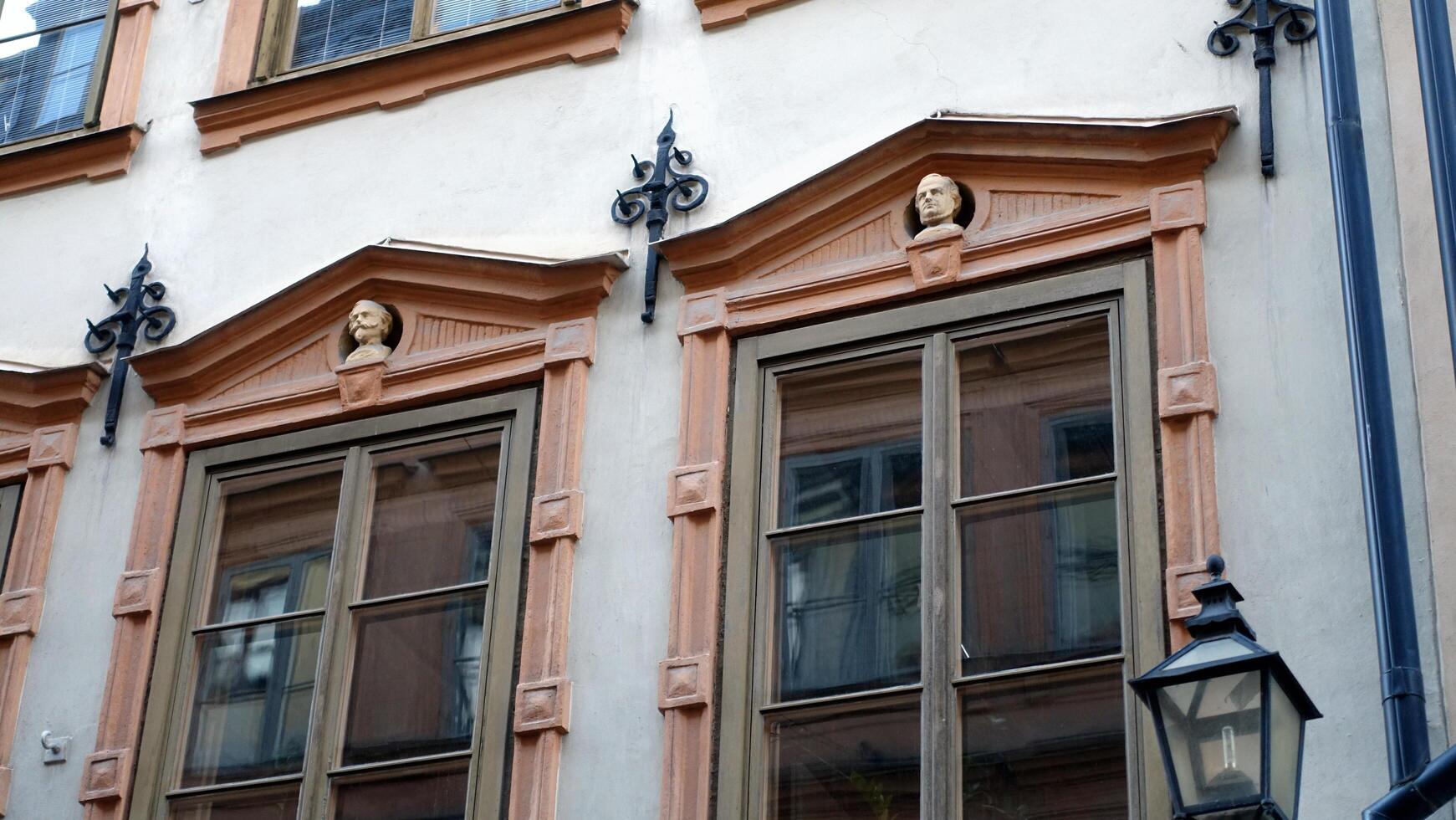 Facade of a historic building in central Stockholm. On the windows you can see the heads of characters from Italian history. photo