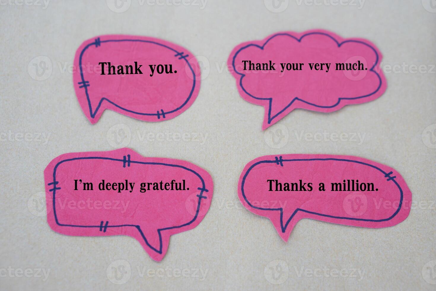 Pink paper bubble speech cards with text Thank you, Thank you very much, I'm deeply grateful, Thanks a million. Concept, teaching aid for English communication. photo