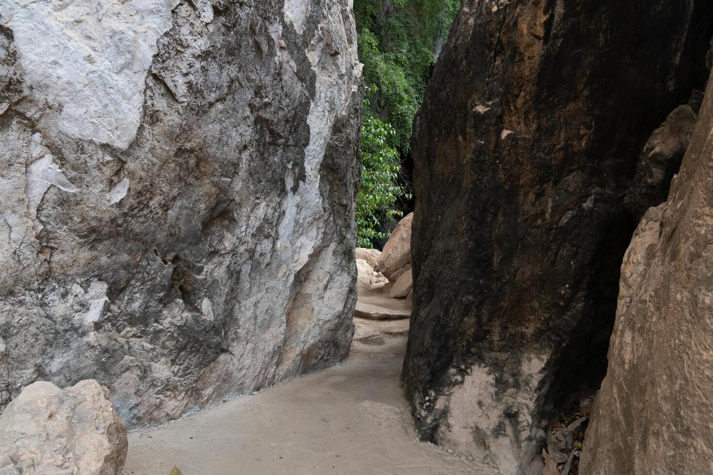 Pathway in the rock. At Wat Tham Khao Bot Tample Wangchan Rayong Thailand. The path between the rocks. photo