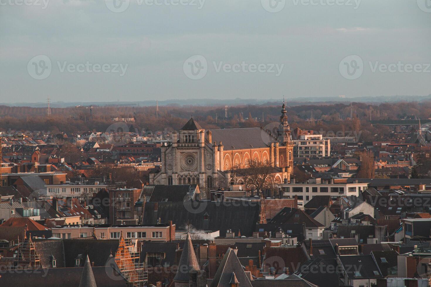 Watching the sunset over Ghent from the historic tower in the city centre. Romantic colours in the sky. Red light illuminating Ghent, Flanders region, Belgium photo