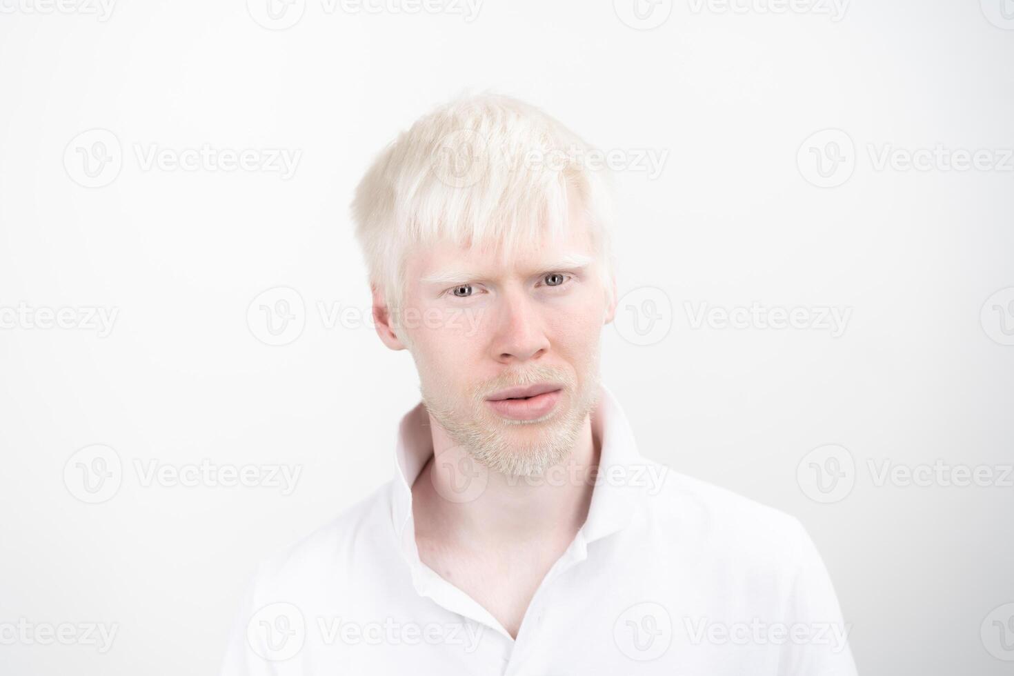 portrait of an albino man in  studio dressed t-shirt isolated on a white background. abnormal deviations. unusual appearance photo