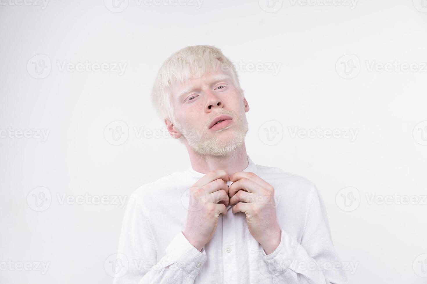 portrait of an albino man in  studio dressed t-shirt isolated on a white background. abnormal deviations. unusual appearance photo