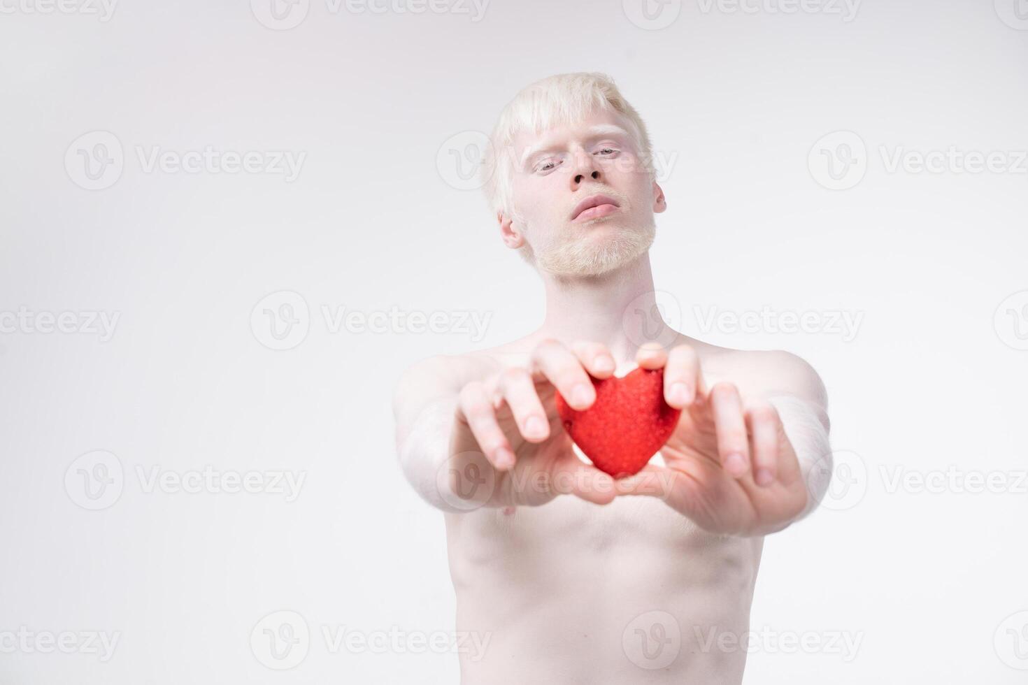 portrait of an albino man in  studio dressed t-shirt isolated on a white background. abnormal deviations. unusual appearance photo