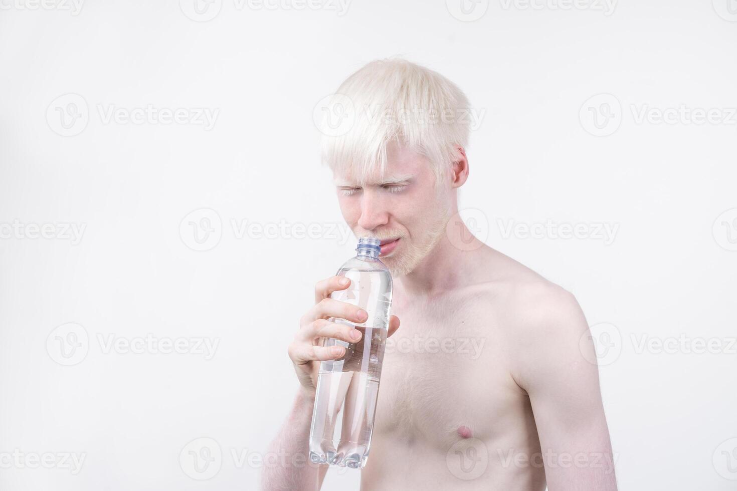 portrait of an albino man in  studio dressed t-shirt isolated on a white background. abnormal deviations. unusual appearance photo