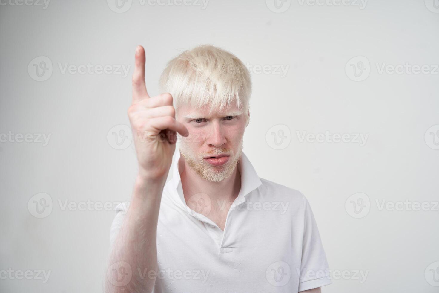 portrait of an albino man in studio dressed t-shirt isolated on a white background. abnormal deviations. unusual appearance photo