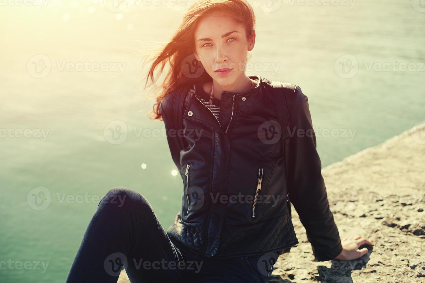 beautiful woman in jeans and jacket. Sea photo