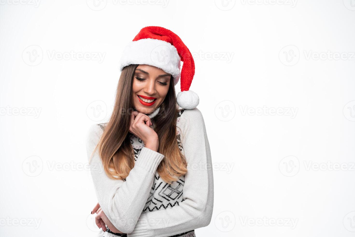 Close up portrait beautifiul caucasian woman in red Santa hat on white studio background. Christmas and New Year holiday concept. photo