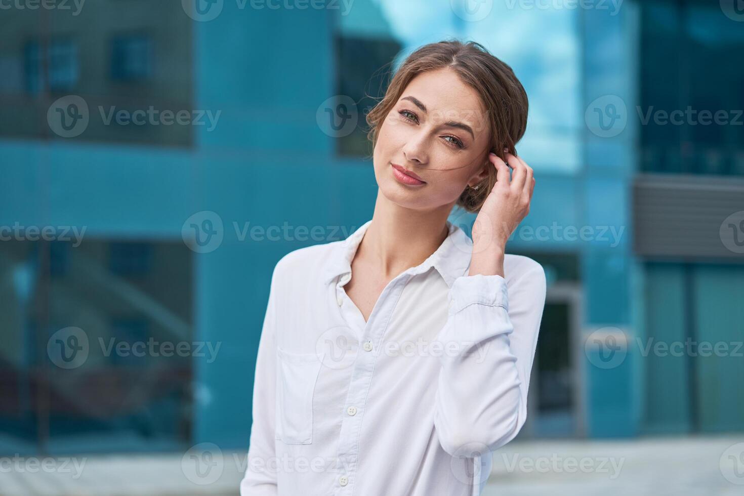 Businesswoman successful woman business person standing outdoor corporate building exterior. Pensiv caucasian confidence professional business woman middle age photo