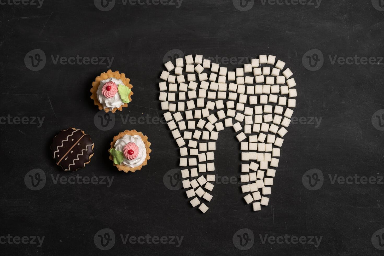 Sugar destroy tooth enamel leads tooth decay Sugar cubes form tooth on black background photo