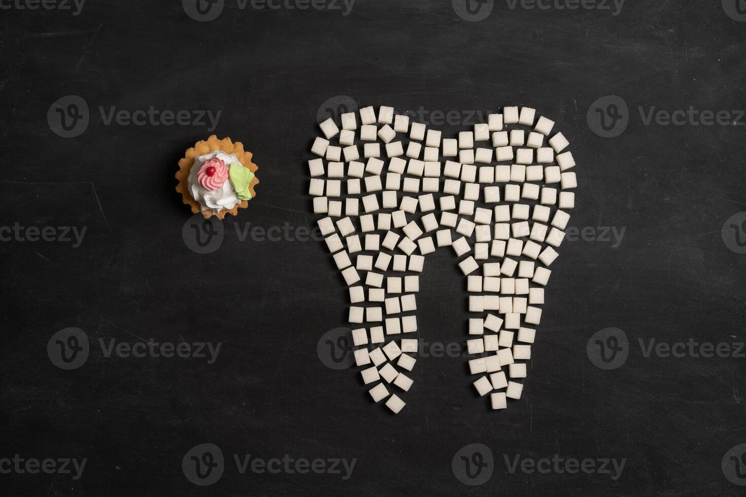 Sugar destroy tooth enamel leads tooth decay Sugar cubes form tooth on black background photo