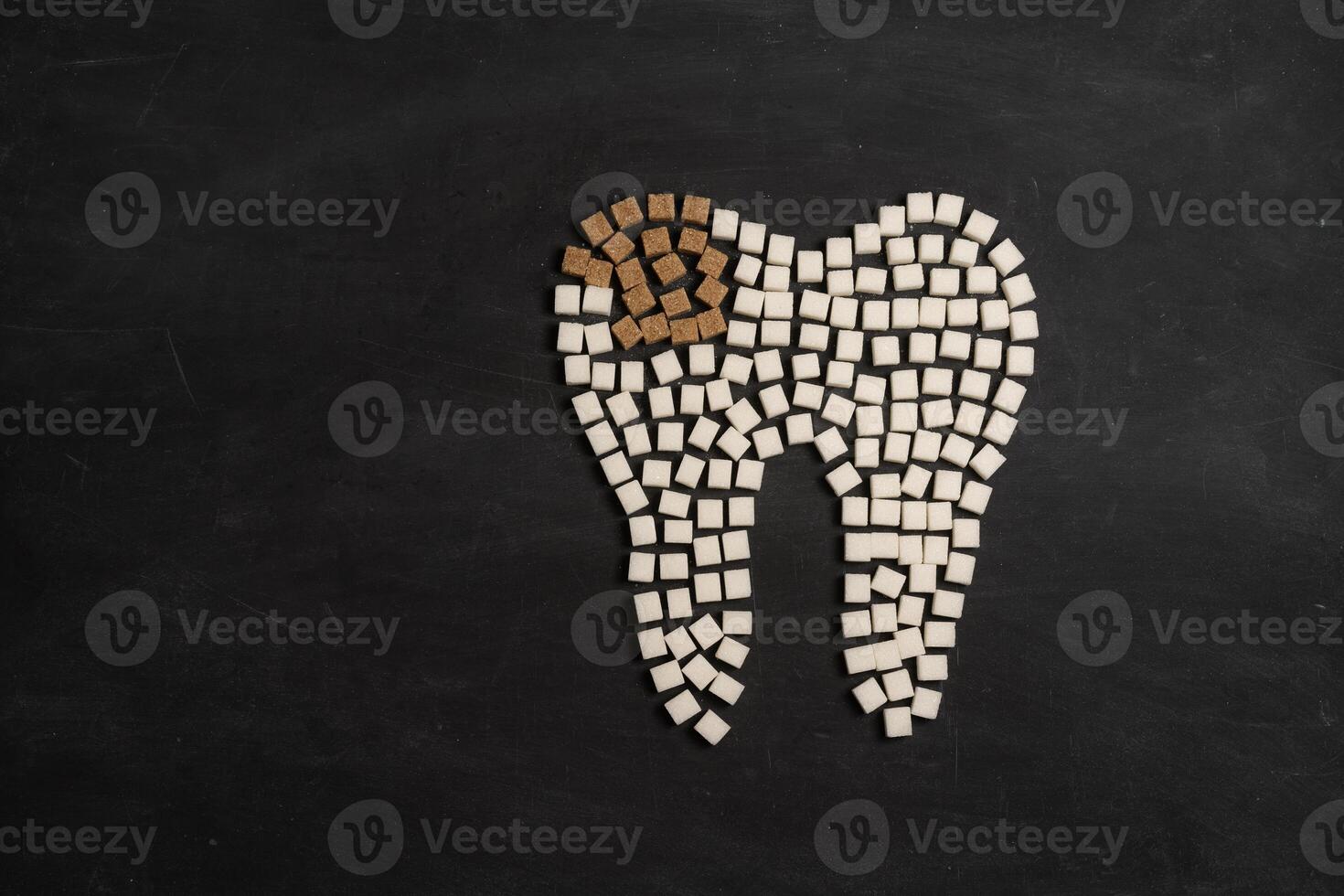 Sugar destroy tooth enamel leads tooth decay Sugar cubes form tooth on black background photo