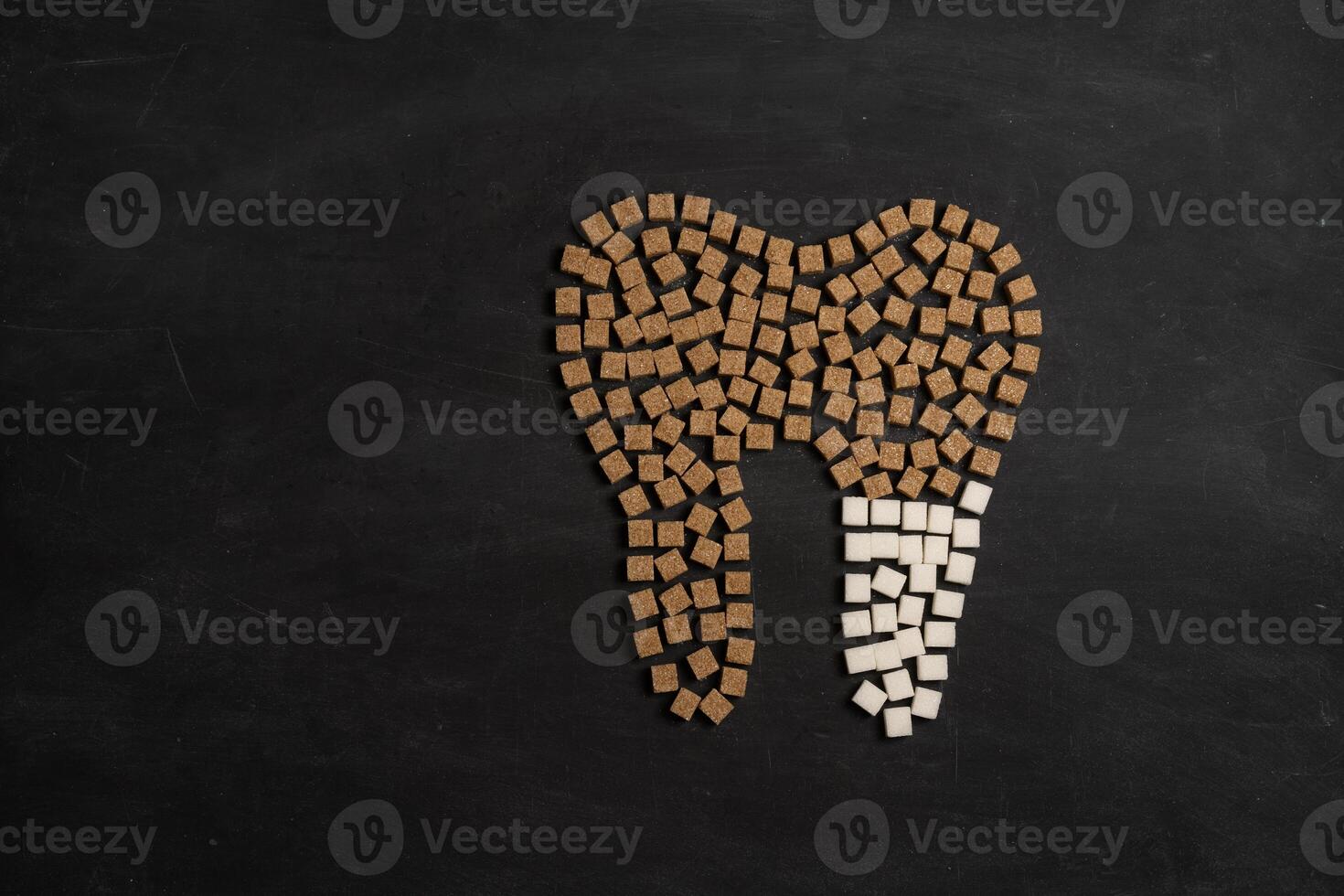 Sugar destroy tooth enamel leads tooth decay Sugar cubes form tooth on black background photo