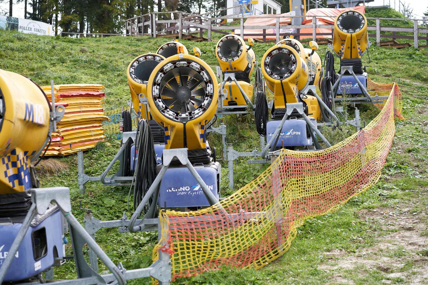 Bukovel, Ukraine October 2020 Snow cannon standing grass autumn season waiting wintertime photo