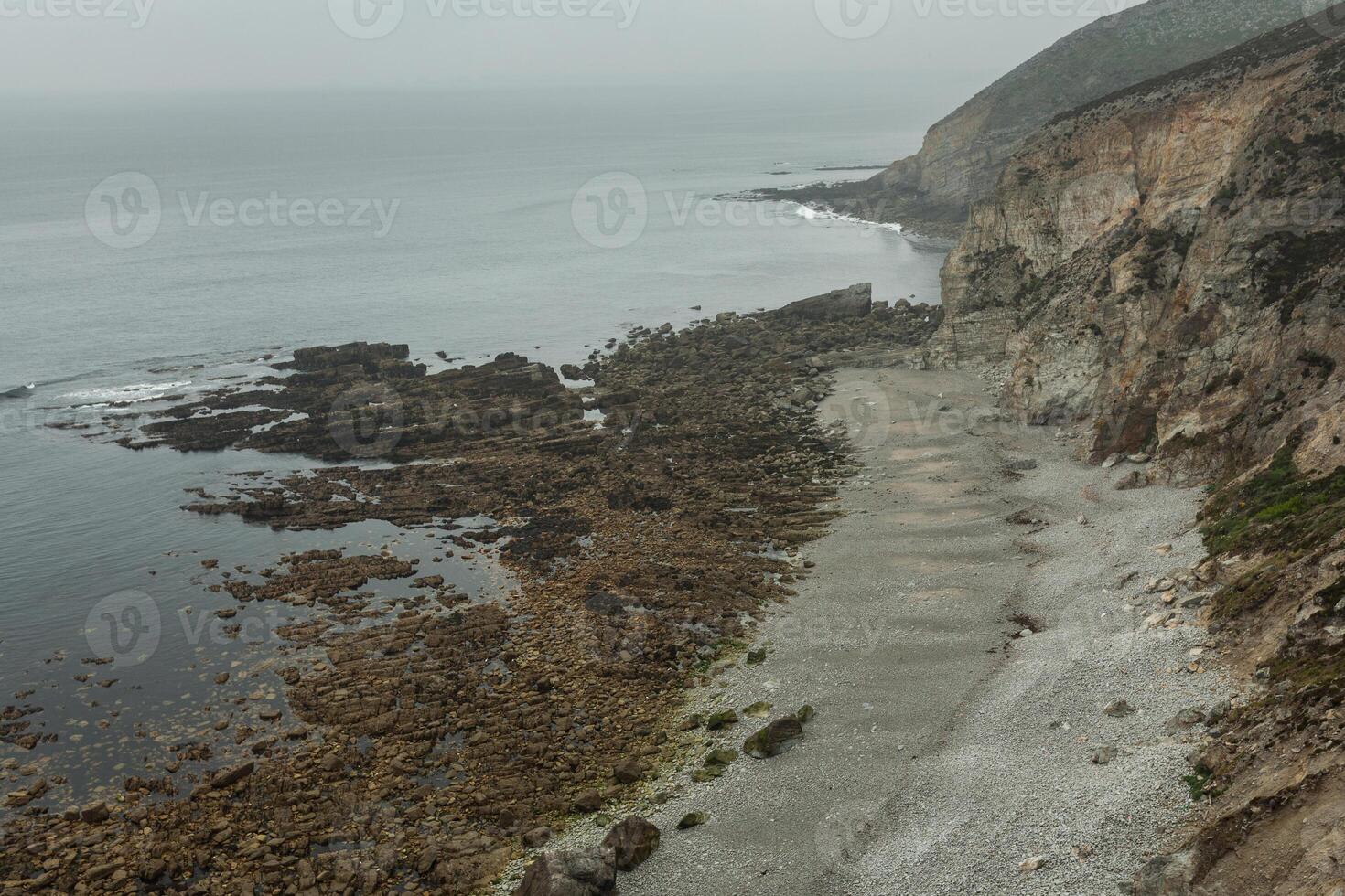 Summer Atlantic rocky coast view Big stony rockfall on precipice shore and ocean surf waves. Crozon, France View near the Memorial naval aviation Cape of the Goat May 2018 photo