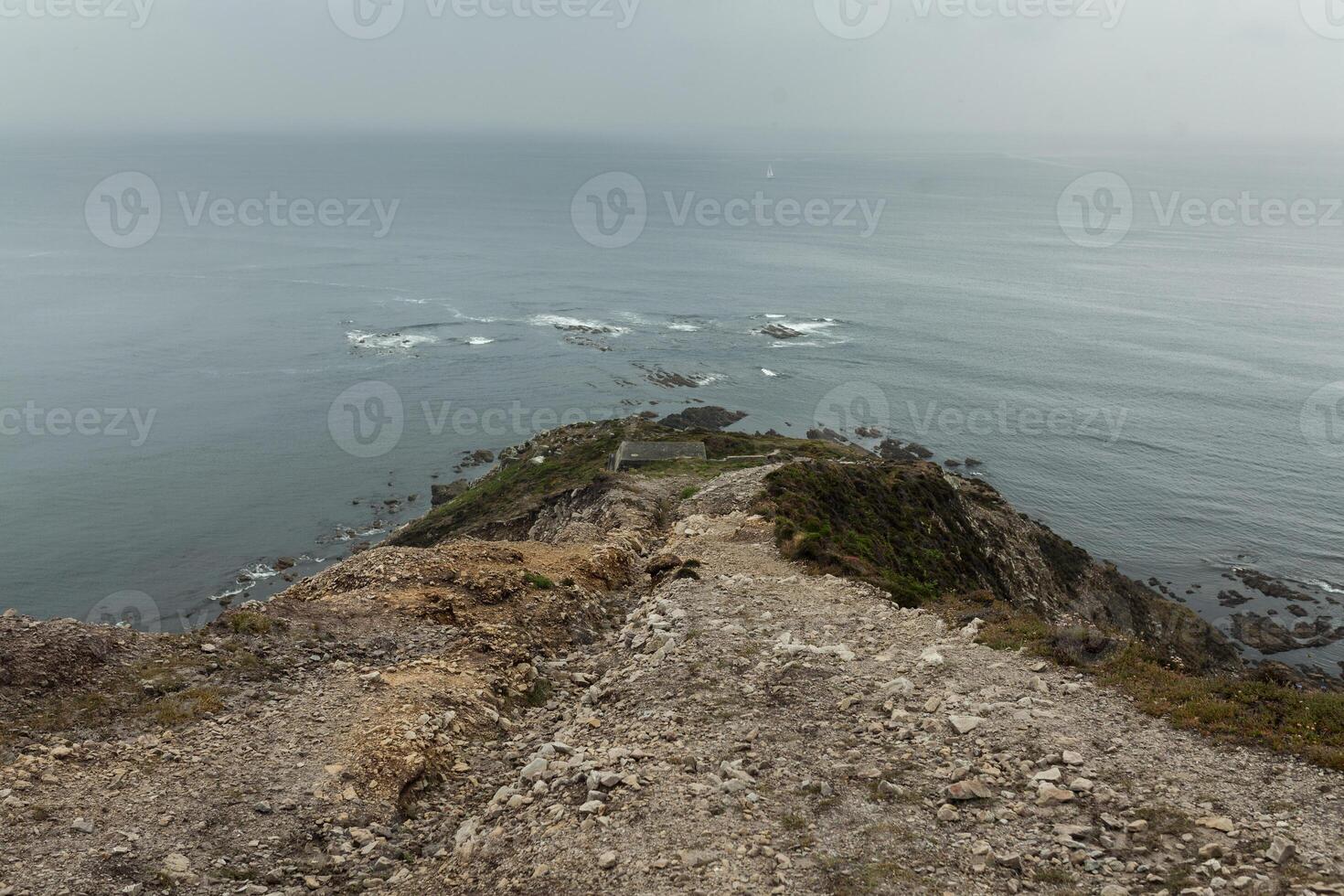 Summer Atlantic rocky coast view Big stony rockfall on precipice shore and ocean surf waves. Crozon, France View near the Memorial naval aviation Cape of the Goat May 2018 photo