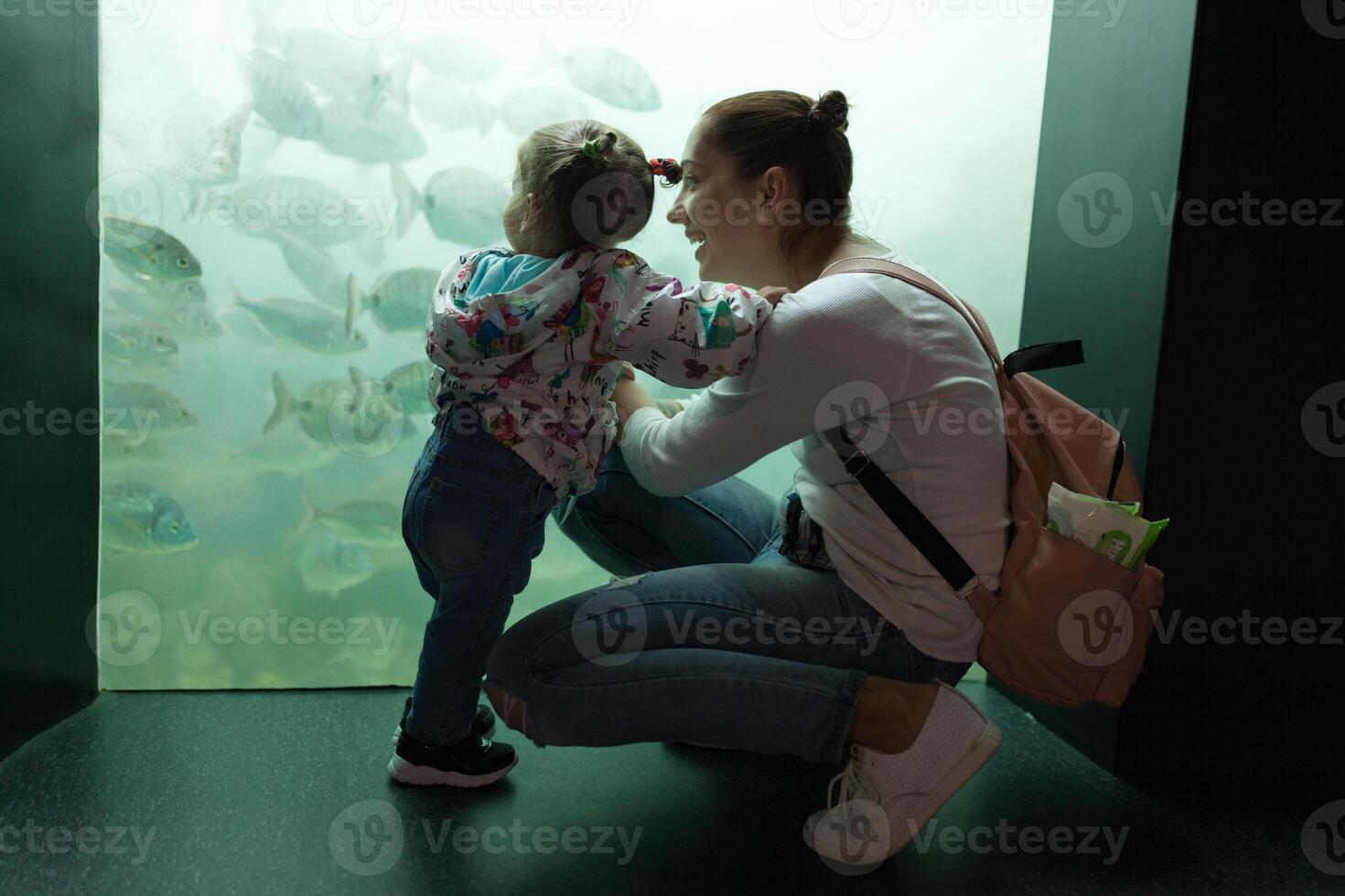 Brest, France 31 May 2018 Mom and his little daughter are looking at sea fish and animals in the aquarium of the Oceanopolis photo