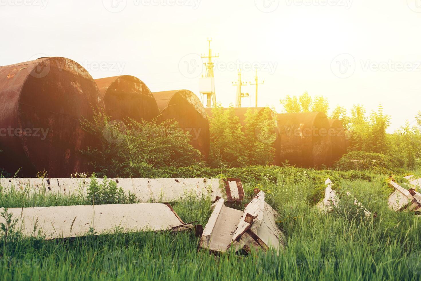 An old rusty tanker for gasoline is thrown in old technopark of Chernobyl after accident at nuclear power plant. Apocalypse, Pripyat. Radiation. Abandoned rusty vehicle technology photo