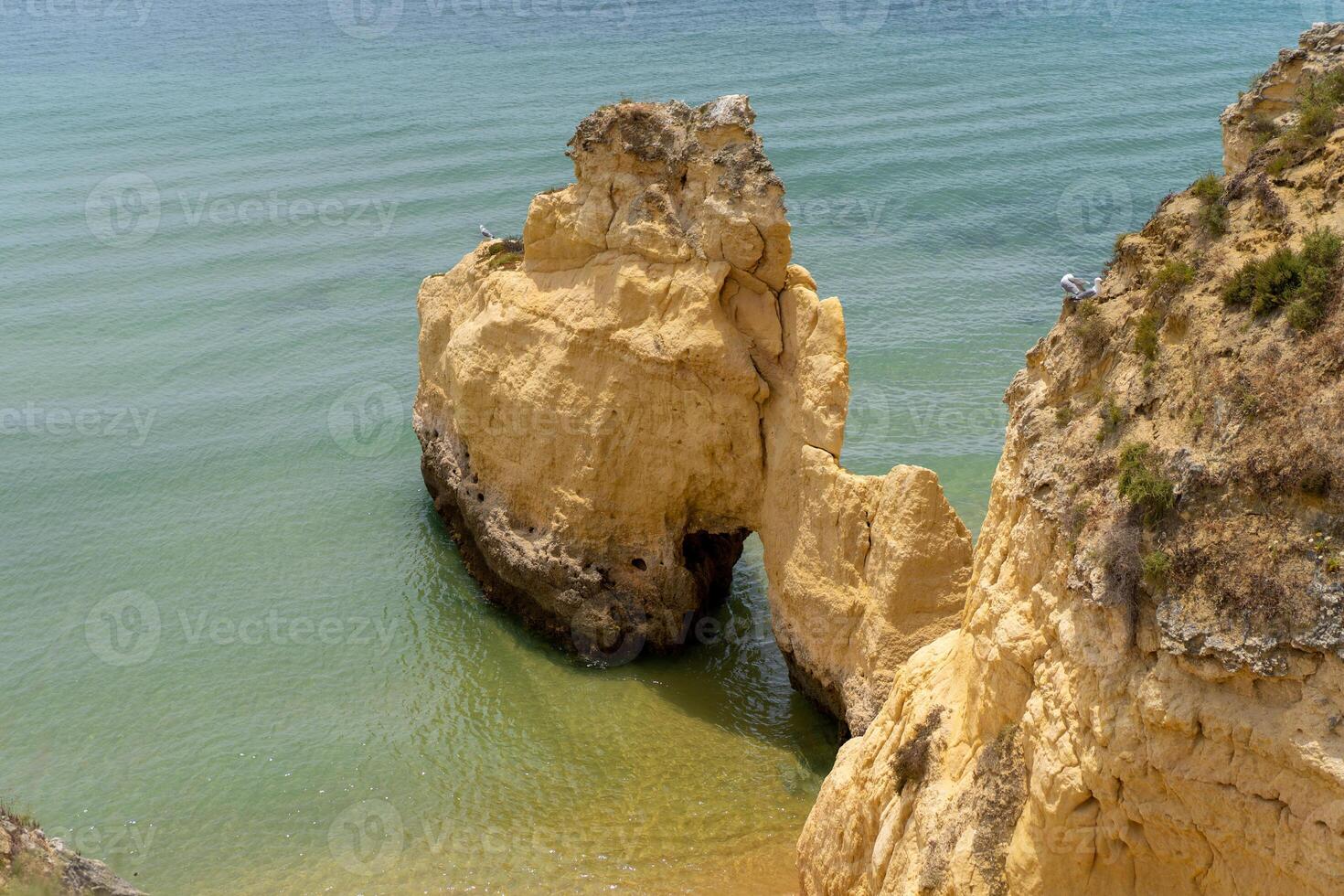 The rocky cliffs of Vale do Olival beach in Armacao de Pera, Portugal photo