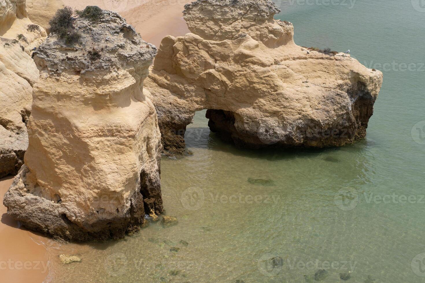 The rocky cliffs of Vale do Olival beach in Armacao de Pera, Portugal photo