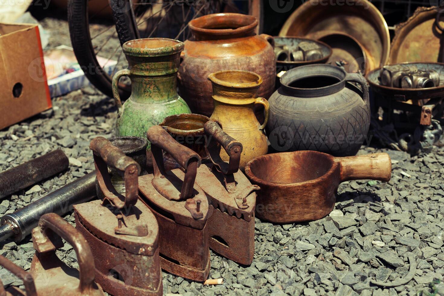 old iron and jugs at a flea market photo