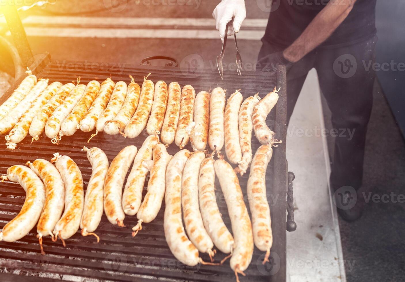 BBQ with fiery sausages on the grill photo