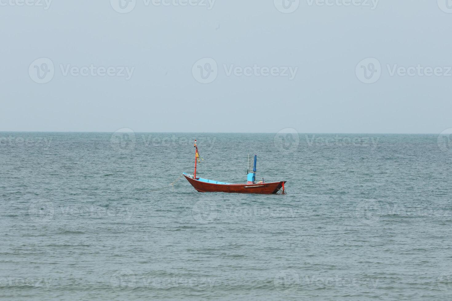 Colorful fishing boat floating on the sea. photo