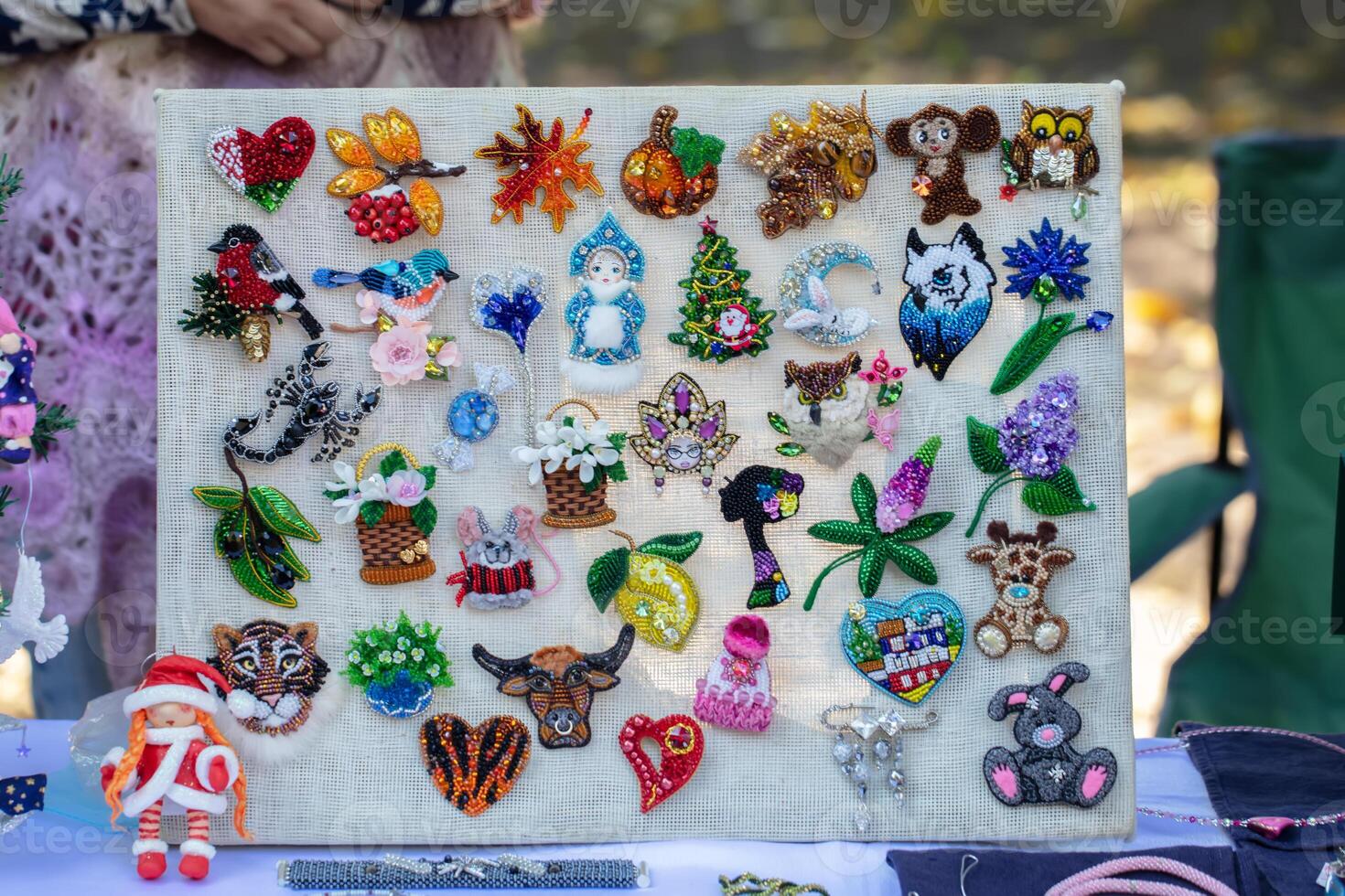 Beautiful varied and multi-colored handmade brooches. photo