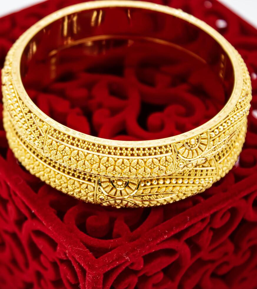 Indian design gold bangle isolated on white background photo