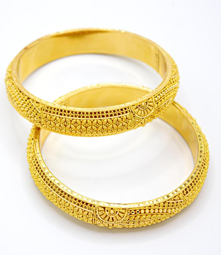 Indian design gold bangle isolated on white background photo