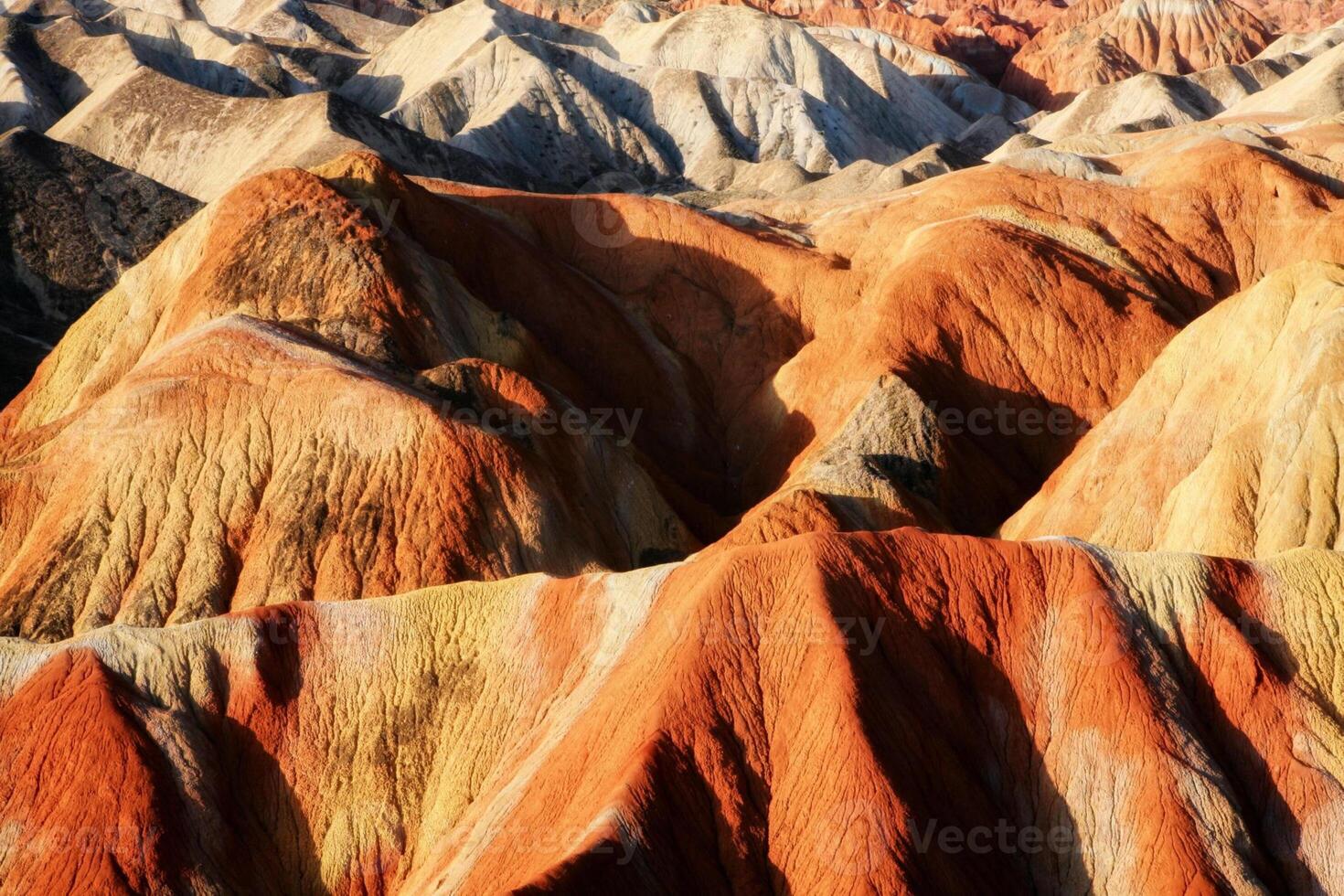 Amazing scenery of china mountains and blue sky background in sunset. Zhangye Danxia National Geopark, Gansu, China. Colorful landscape, rainbow hills, unusual colored rocks, sandstone erosion photo