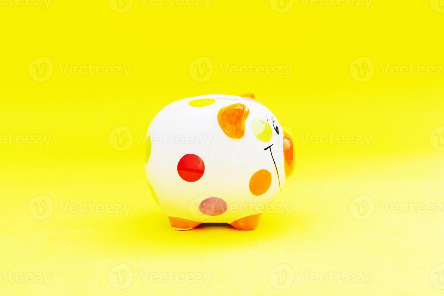 Piggybank on a yellow background. to save , saving money for affordable things, financial concept .Piggybank or deposit box on a wood background, depict saving money to make a trust fund for children photo