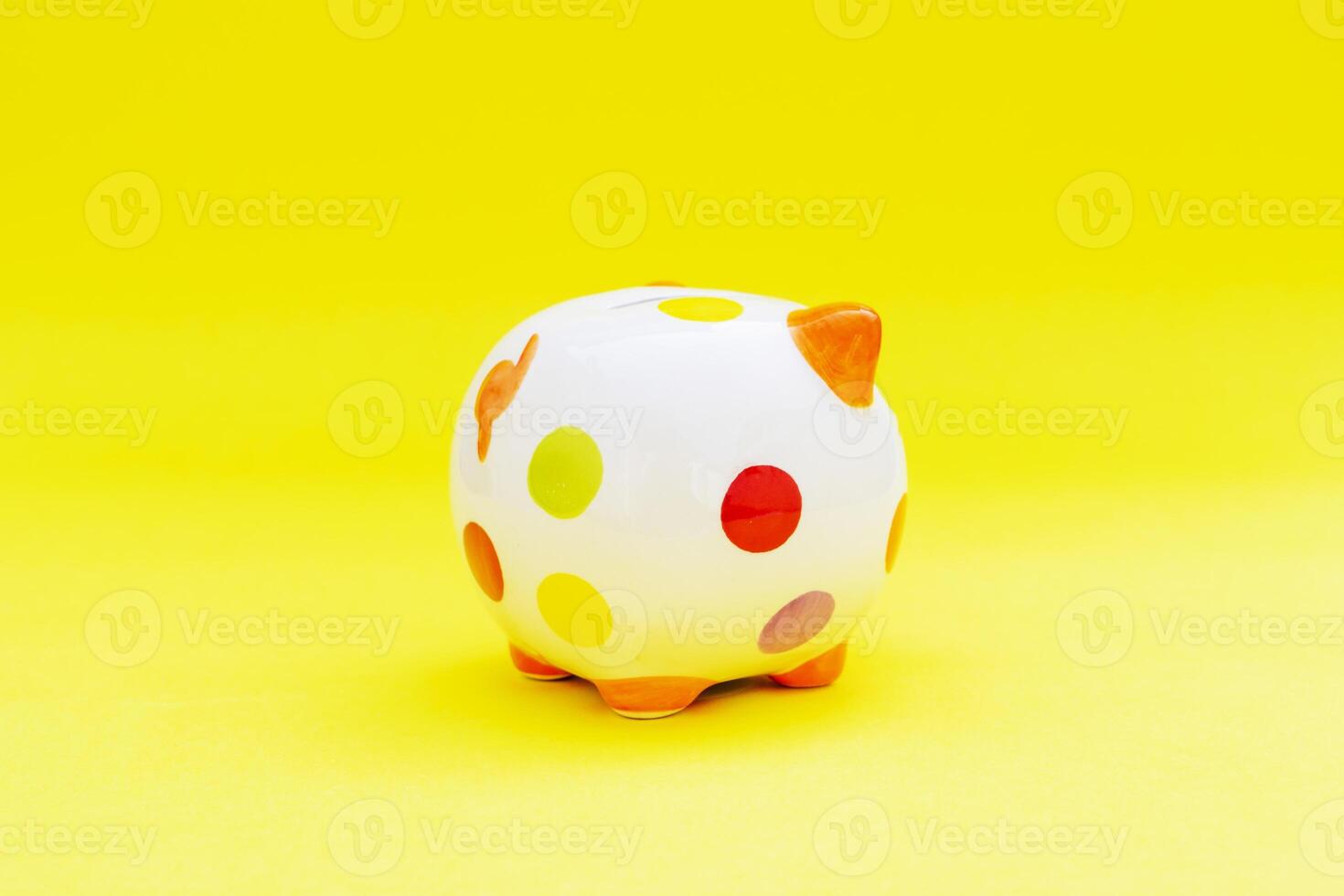 Piggybank on a yellow background. to save , saving money for affordable things, financial concept .Piggybank or deposit box on a wood background, depict saving money to make a trust fund for children photo