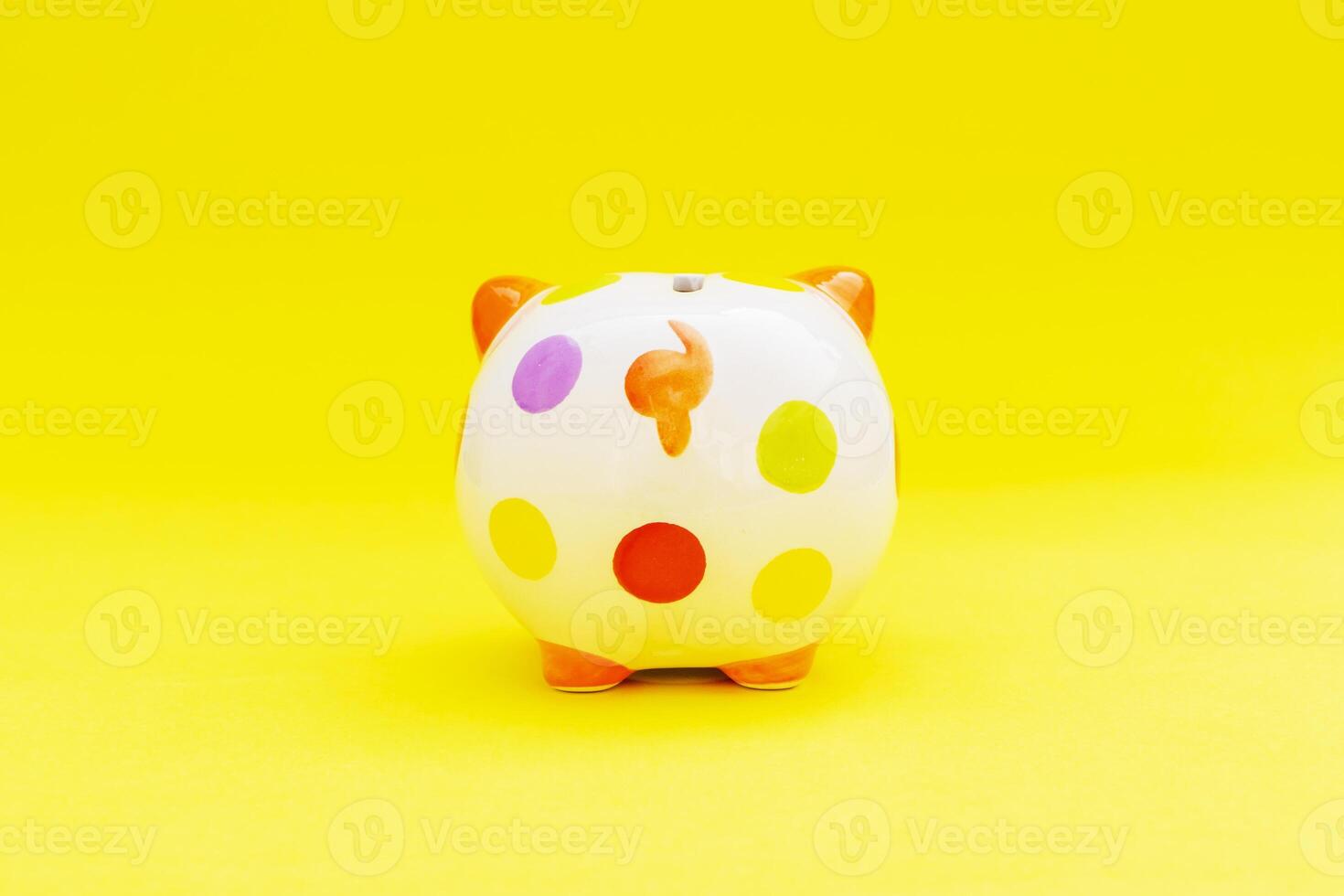 Piggybank on a yellow background. to save , saving money for affordable things, financial concept .Piggybank or deposit box on a wood background, depict saving money to make a trust fund for children photo