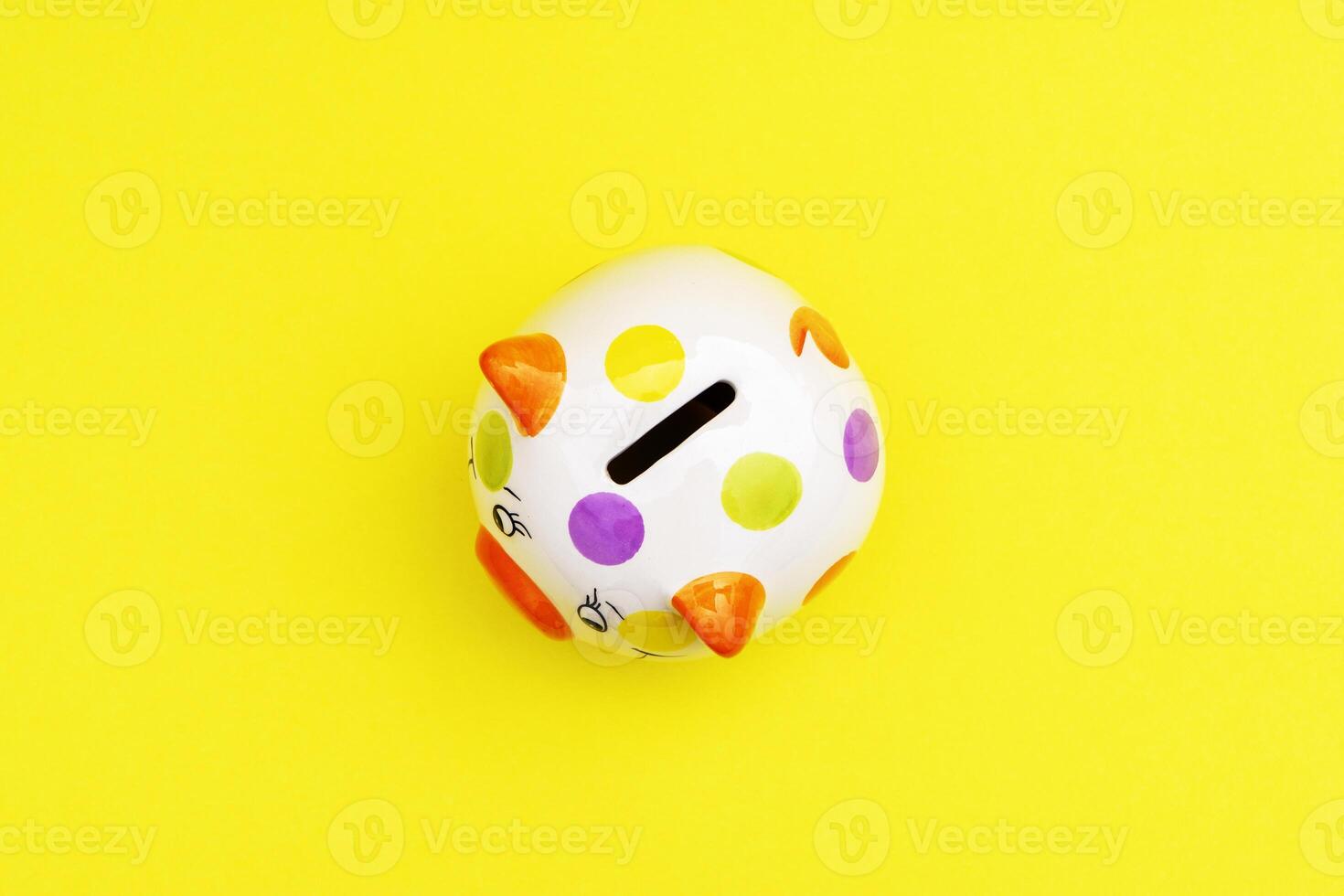 Piggybank on a yellow background. to save , saving money for affordable things, financial concept .Piggybank or deposit box on a wood background, depict saving money to make a trust fund for children photo
