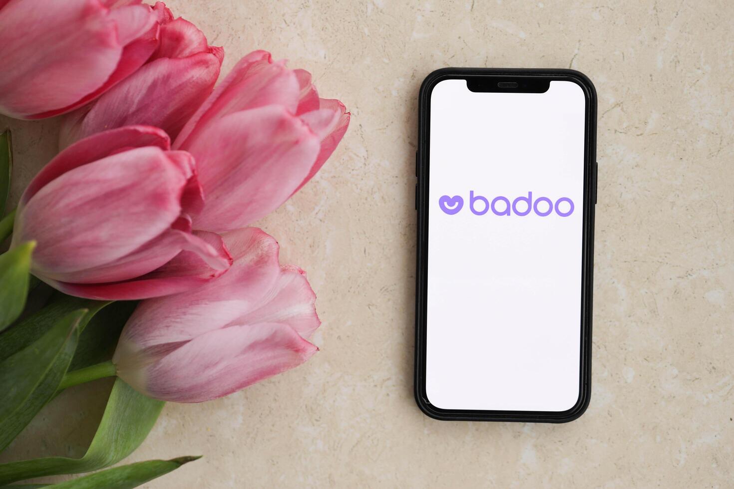 KYIV, UKRAINE - FEBRUARY 23, 2024 Badoo logo of famous dating website or app on iPhone display photo
