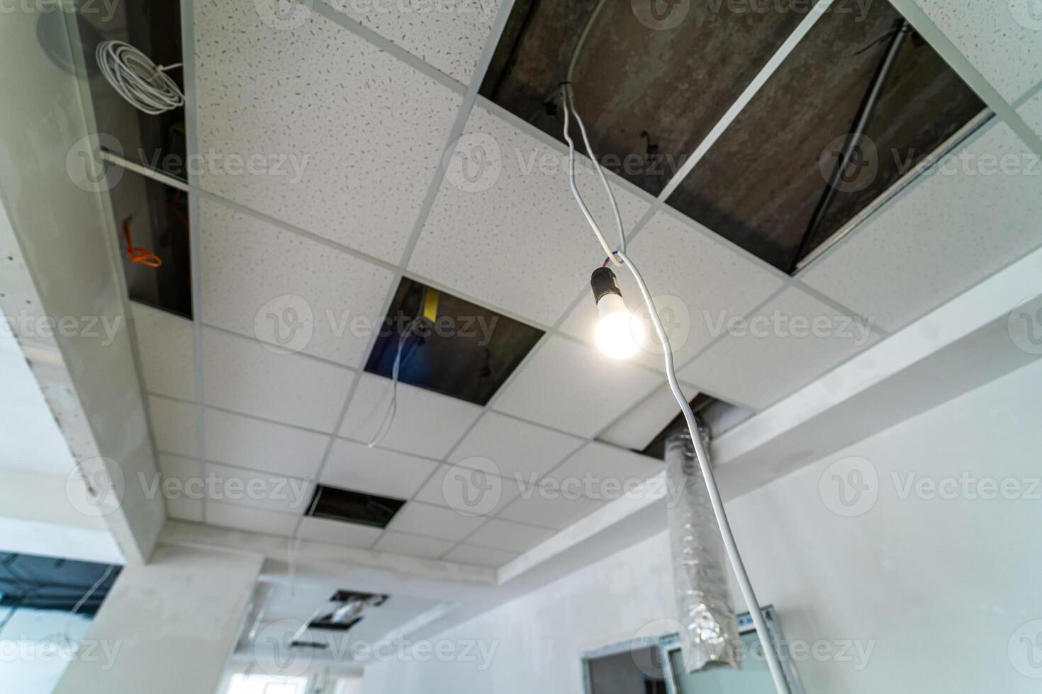 Security and fire alarm on the ceiling in administrative building. Square places for lamps built inside the ceiling photo