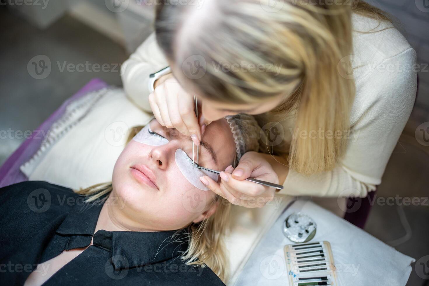 Eyelash extension procedure in beauty salon. Lashes close up. Concept spa lash. photo