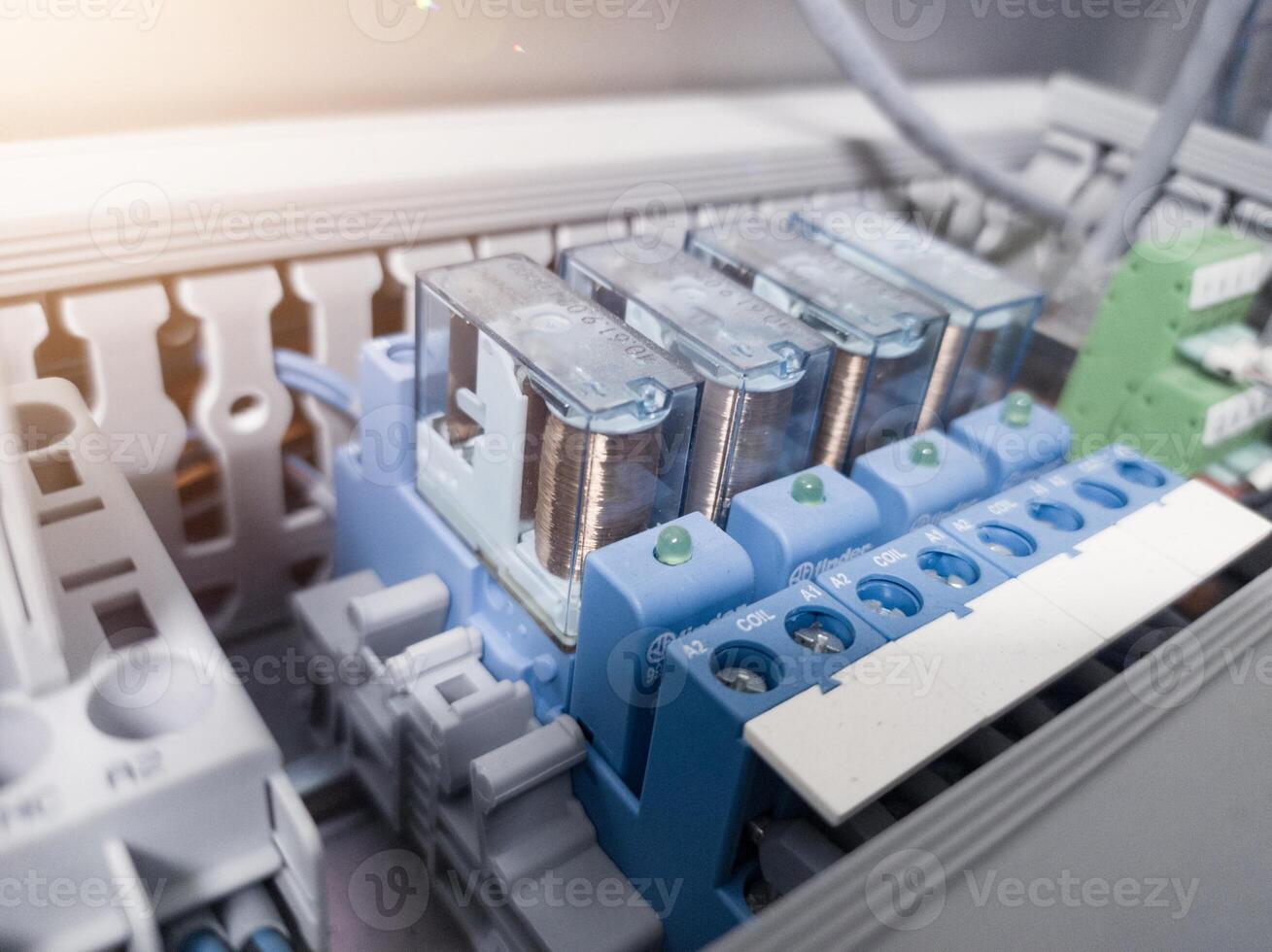 Close up the relays control with indicator on light on the panel board machinery . photo