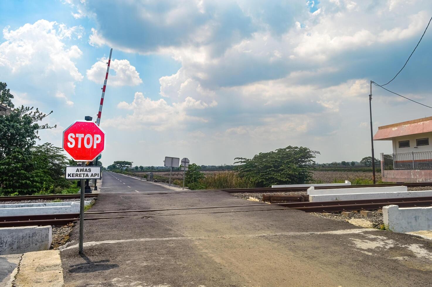 a deserted railroad crossing with no vehicles passing by. photo