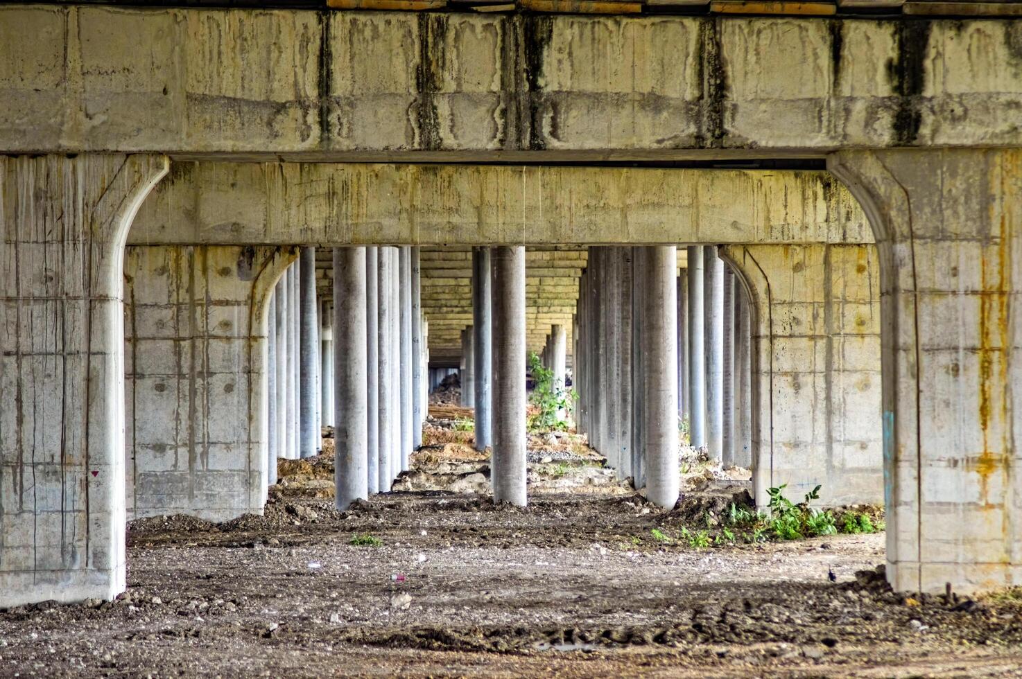 under toll road bridges or highways where there are many bridge pillars. perspective view. photo