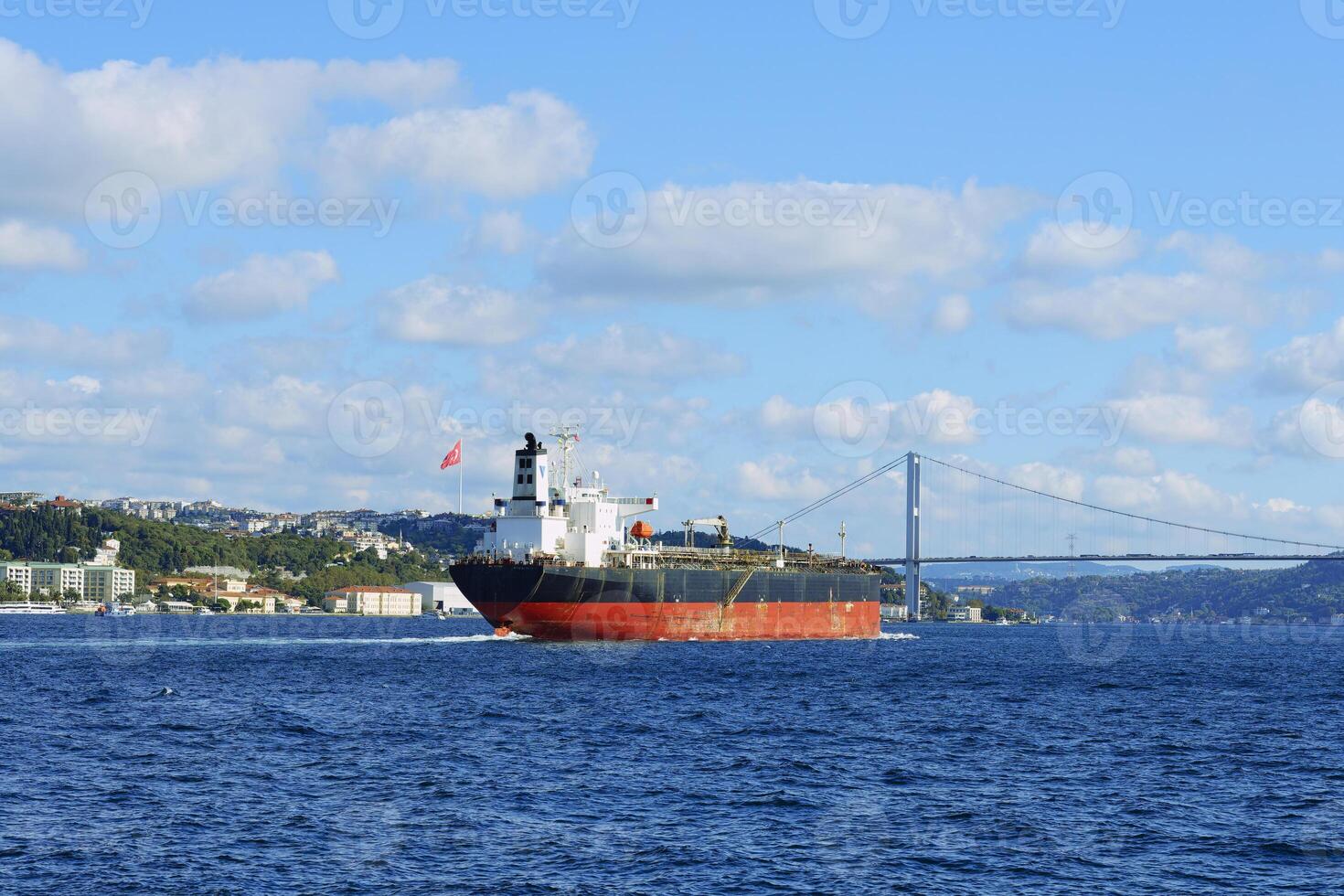 Ship passing the Bosphorus Bridge at Besiktas, Istanbul, Turkey photo