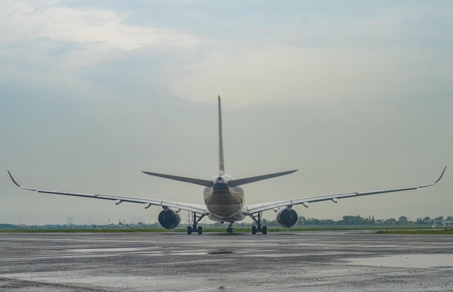 rear view of a wide body Airbus A350-941 aircraft belonging to Singapore Airline with wide wings on the taxi way at Juanda International Airport, Surabaya in Sidoarjo, Indonesia, 6 January 2024 photo