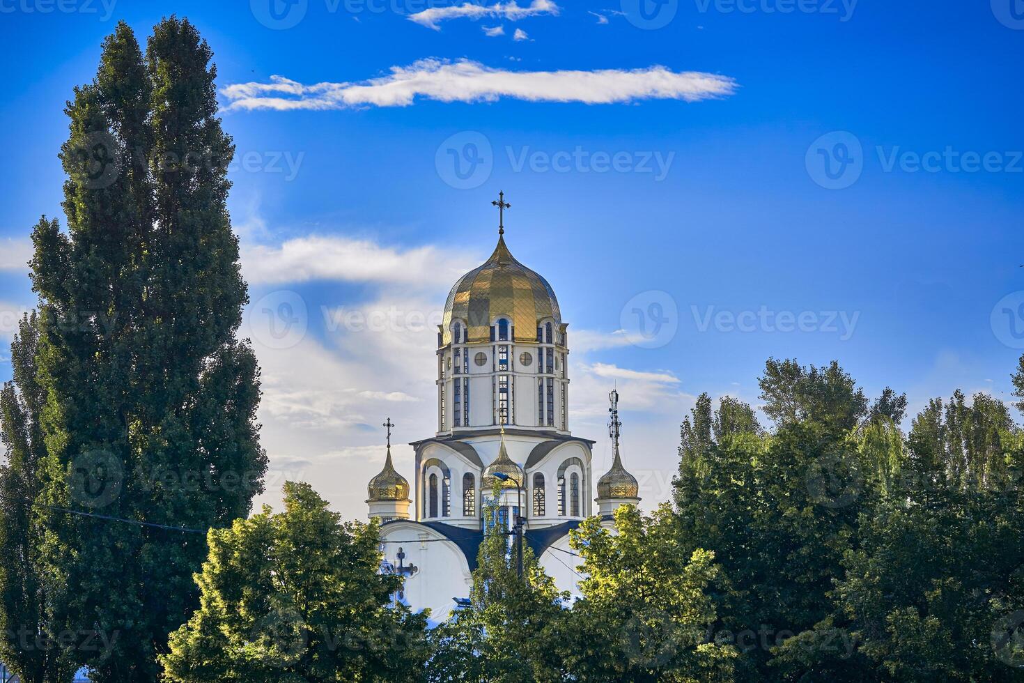 Beautiful church, green trees and spring sky photo