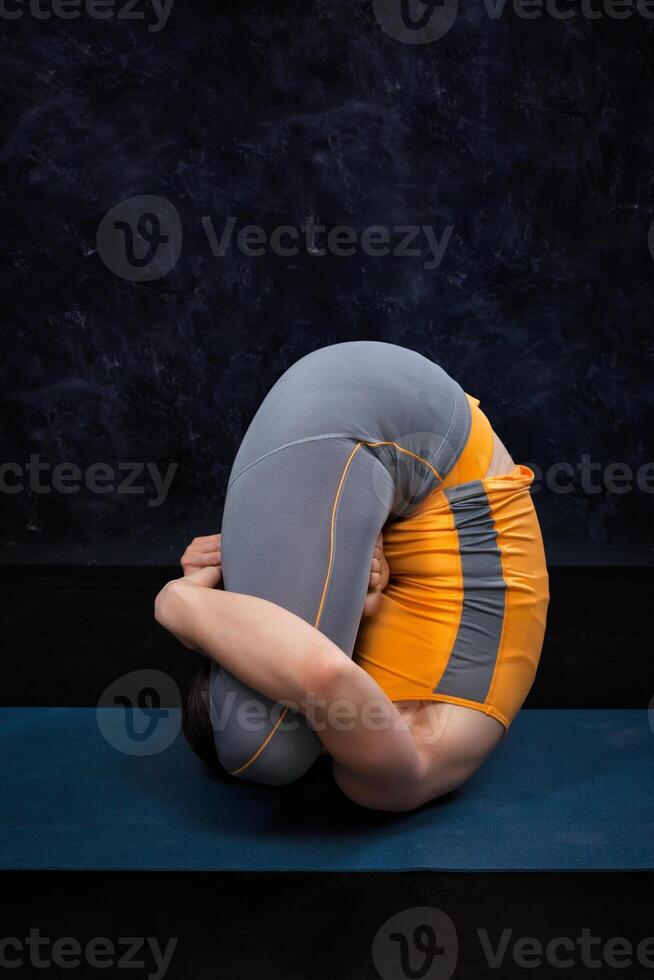 Woman doing Hatha Yoga Ashtanga Vinyasa yoga asana Garbha pindas photo