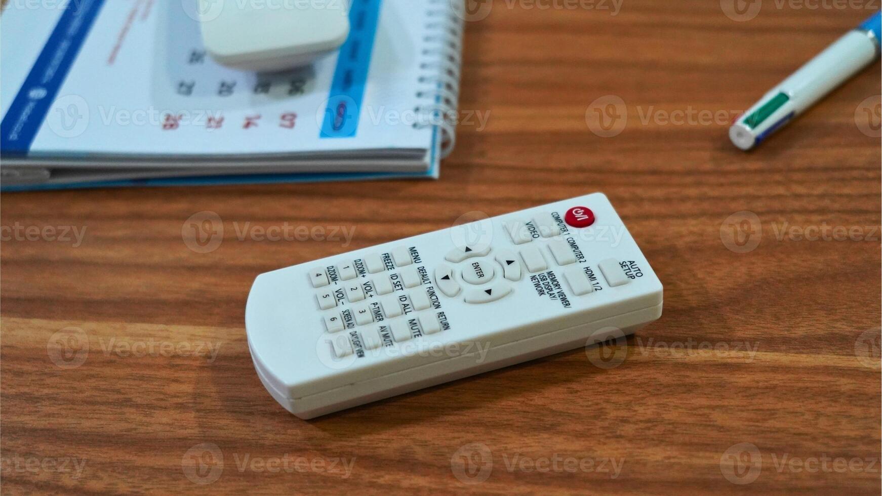 The remote control has various buttons labeled with functions such as MENU, SET, MUTE,and VOL. photo