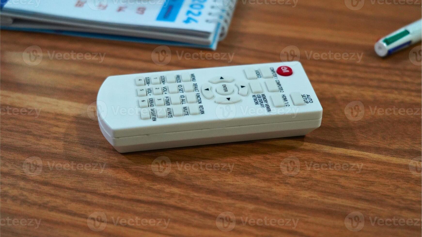 The remote control has various buttons labeled with functions such as MENU, SET, MUTE,and VOL. photo