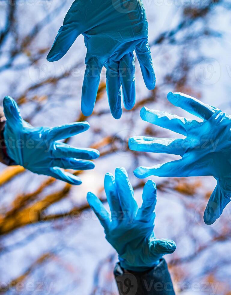 Hands in rubber medical gloves. Family at quarrantine concept. The concept of a pandemic, quarantine, prevention of viruses, diseases. Photo from below.