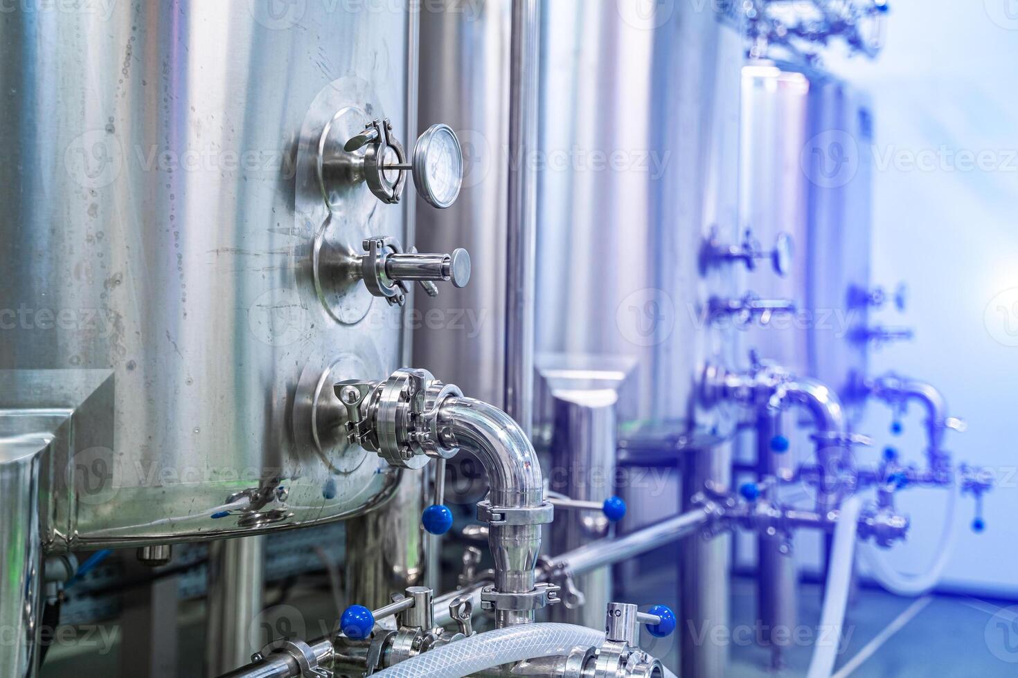 Dairy production. Apparatus for bottling milk products. Steel tanks at milk factory. Dairy factory with milk pasteurization tank and pipes photo