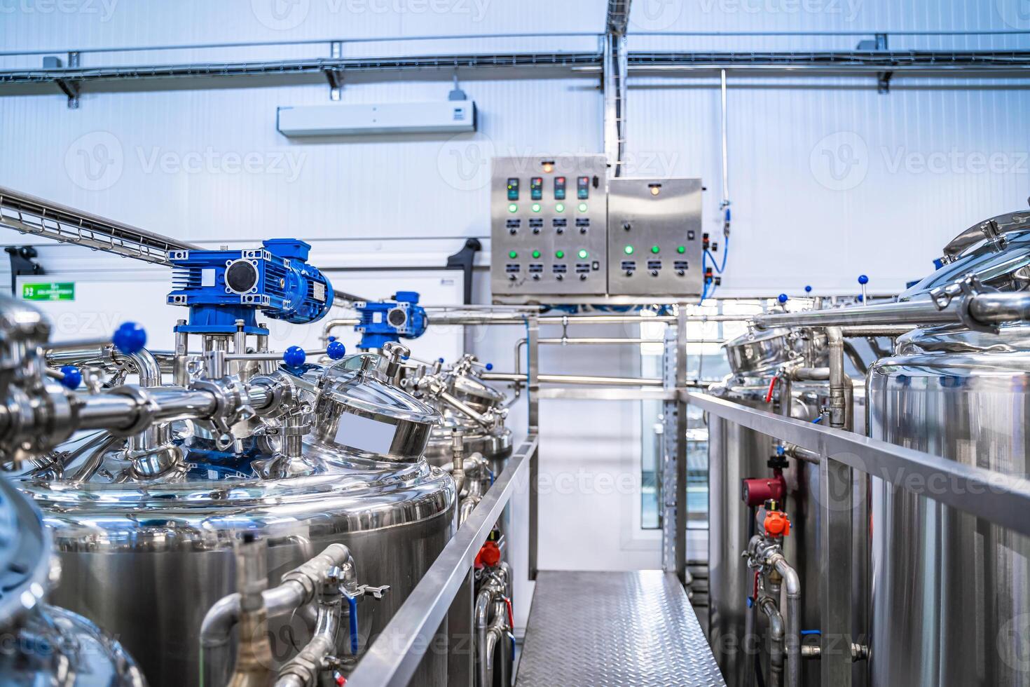Production of yogurt and milk at dairy factory, industrial equipment for fermentation. photo